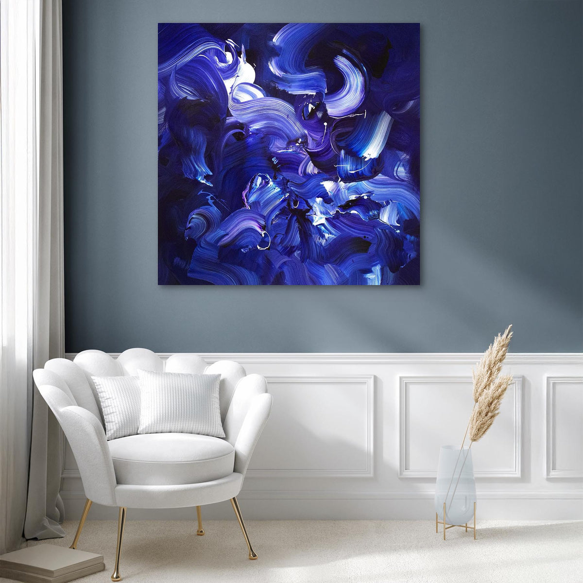 Large blue abstract canvas painting with swirling, fluid shapes and vibrant hues displayed on a wall in a modern, minimalist living room setting.