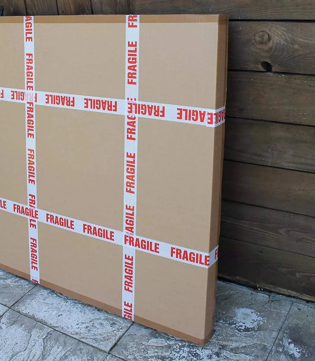 Large fragile cardboard boxes on wooden floor