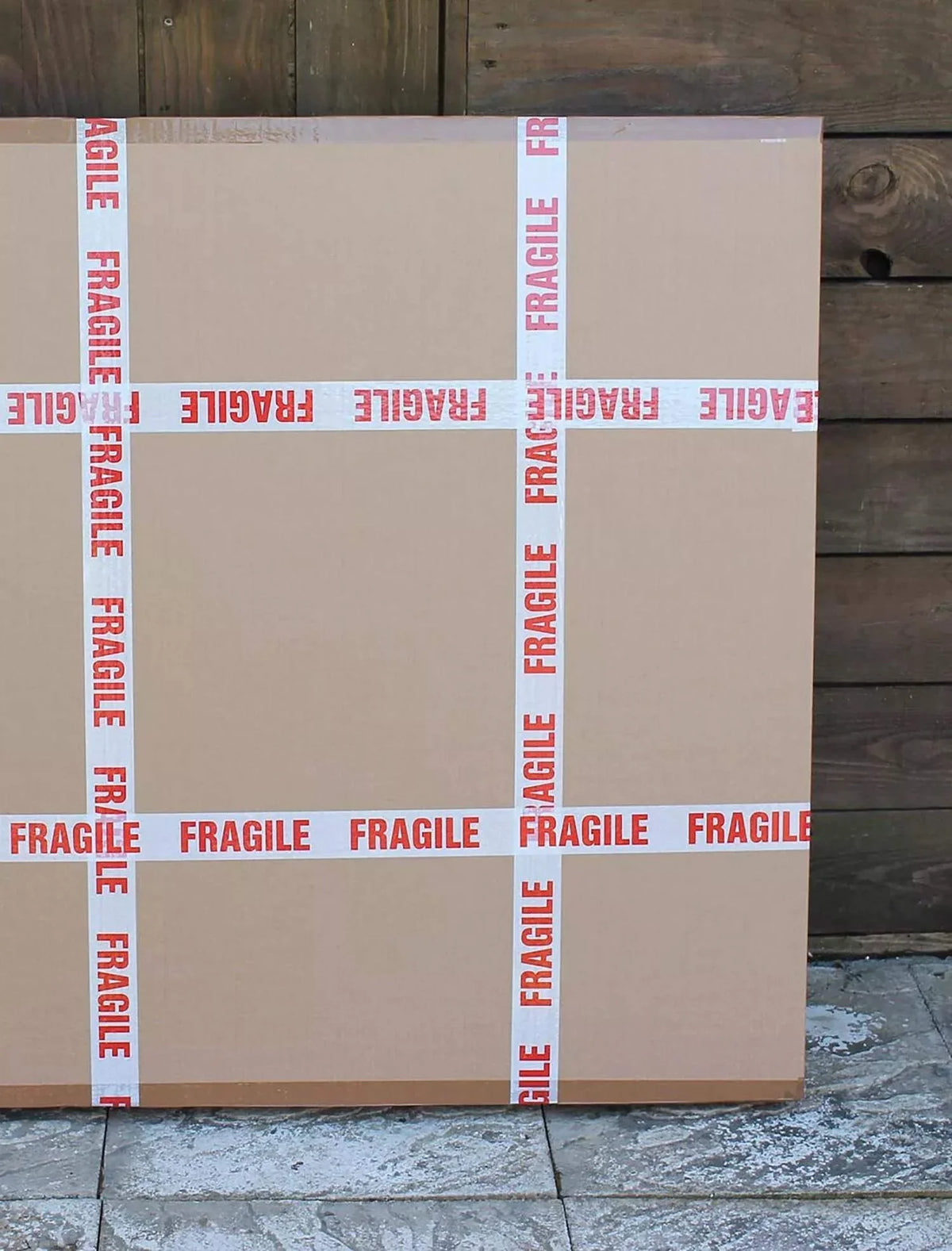 Fragile boxes surrounded by wooden planks in an image
