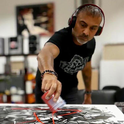 Abstract artist at work creating large-scale contemporary painting in his studio