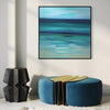 Serene abstract seascape art - framed square canvas featuring calming ocean waves in shades of turquoise and teal, displayed on a white wall with modern furniture.