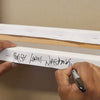 Paresh nrshinga signing his abstract painting