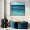 Serene abstract seascape painting with calming blue and green hues, displayed on a white wall alongside modern furniture in a stylish home interior.