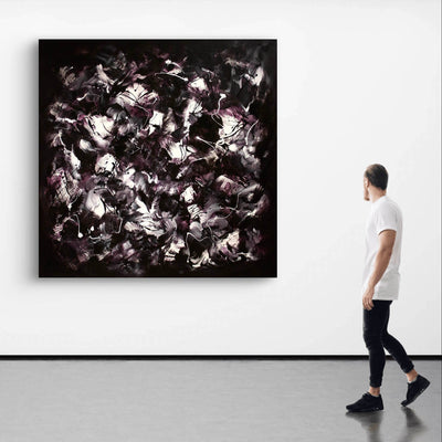 Striking abstract landscape in black, white, and purple tones displayed on gallery wall, complemented by a single person viewing the artwork.