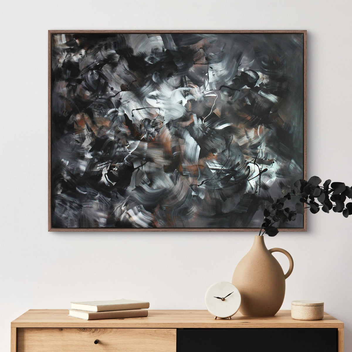 Chromatic Symphony 100x130cm - Abstract art painting with bold brushstrokes and contrasting colours, displayed on a wooden cabinet with minimal decor.
