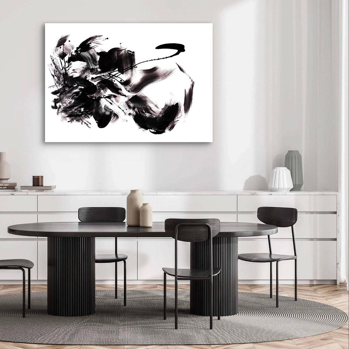 Large abstract black and white artwork depicting dynamic motion on display in modern dining room setting with wooden table and chairs.