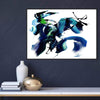 Contemporary abstract artwork titled "Make It Happen II" depicting dynamic, expressive brushstrokes in vibrant blue, green, and black hues. The painting is showcased on a dark wall above a minimalist wood and metal shelving unit displaying decorative objects.