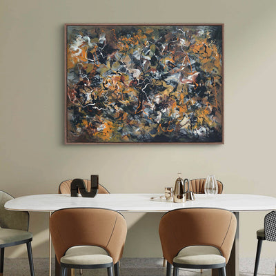 Large abstract portrait artwork in earthy, warm colors displayed on a wall above a white dining table with chairs in a minimalist, modern interior setting.