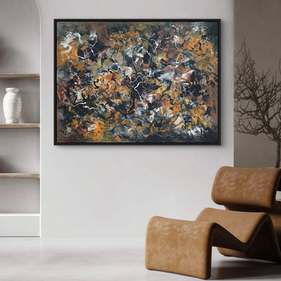 Large abstract painting titled "Dance of Love" displayed on the wall above a leather chair in a modern home decor setting. The painting features a vibrant mix of earthy colors and dynamic brushstrokes, creating an energetic and expressive artwork. The neutral-toned room and natural elements like the wood shelves complement the bold abstract style of the painting, making it the focal point of the space.