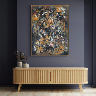 Vibrant abstract canvas art with earthy hues and textured brushstrokes, mounted on a dark gray wall above a wooden sideboard, creating a modern and artistic home decor setting.