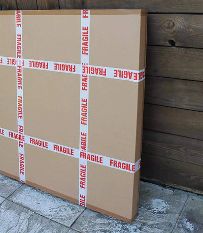 Large fragile cardboard boxes on wooden floor